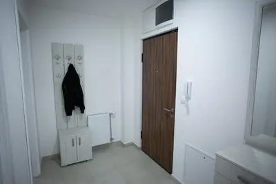a white room with a door and a closet at Apartman Ub in Ub