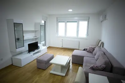 a living room with a couch and a tv at Apartman Ub in Ub