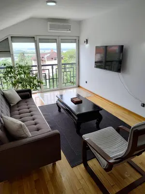 a living room with a couch and a coffee table at Apartman Visnjica in Rospi Ćuprija