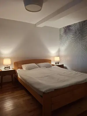 a bedroom with a bed with two lamps on two tables at Park in Lazarevac