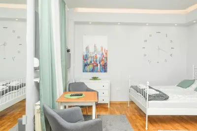 a small room with a crib and a table at Studio 91 with Great WI-FI and free parking in Belgrade