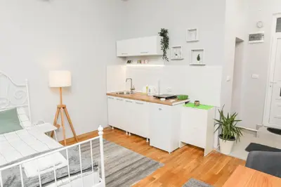 a white kitchen with a sink and a counter at Studio 91 with Great WI-FI and free parking in Belgrade