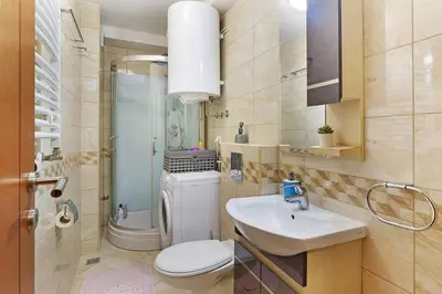 a bathroom with a toilet and a sink and a shower at Apartment SEIF 2 in Belgrade