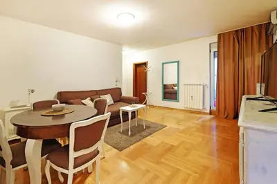 a living room with a table and a couch at Apartment SEIF 2 in Belgrade