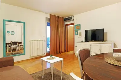 a living room with a table and a television at Apartment SEIF 2 in Belgrade