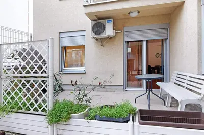 a patio with a bench and a table and a window at Apartment SEIF 2 in Belgrade