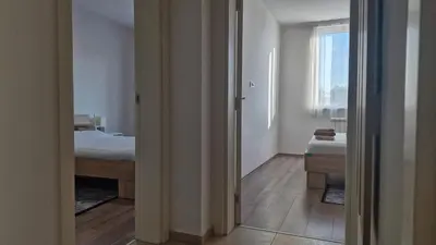 a bedroom with a bed and a window and a mirror at Banjica Stan 203 in Belgrade