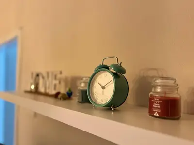 a green alarm clock sitting on a shelf at Apartment Wellness in Belgrade