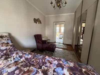 a bedroom with a bed and a chair and a mirror at Apartment Wellness in Belgrade