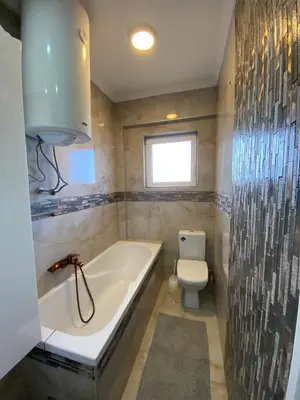a bathroom with a bath tub and a toilet at Apartment Wellness in Belgrade