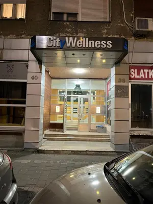 a store front of a building with a car parked outside at Apartment Wellness in Belgrade