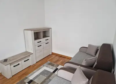 a living room with a couch and a table at Stan na dan Beograd in Mirijevo