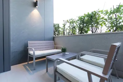 a couple of chairs and tables on a balcony at Giulia apartment Belgrade Novi Dorcol in Belgrade