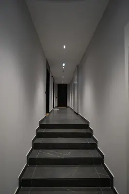 a hallway with stairs leading up to a door at Giulia apartment Belgrade Novi Dorcol in Belgrade