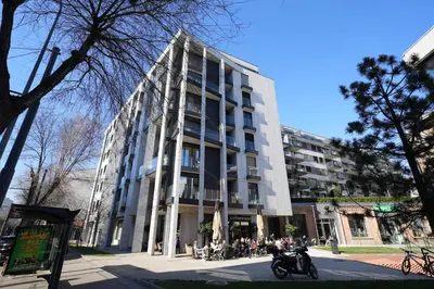 a large building with people sitting outside of it at Giulia apartment Belgrade Novi Dorcol in Belgrade