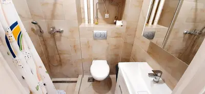a bathroom with a toilet and a shower and a sink at Apartman Studenjak in Tošin Bunar