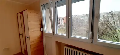 a room with three windows and a radiator in front at Apartman Studenjak in Tošin Bunar