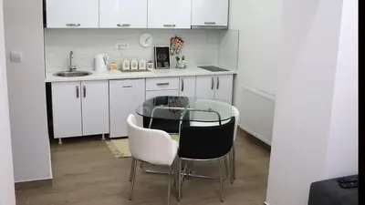 a kitchen with a table and chairs in a room at XENIA2 in Belgrade