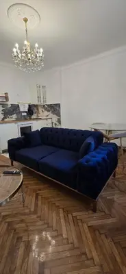 a blue couch sitting in a living room at Admiral Gate in Belgrade