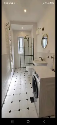 a bathroom with a sink and a washing machine at Admiral Gate in Belgrade