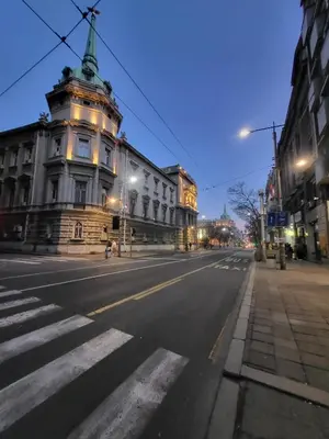 an empty city street with a building with a crosswalk at Admiral Gate in Belgrade