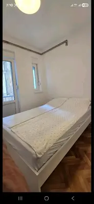 a large bed in a room with a window at Admiral Gate in Belgrade
