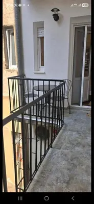 a porch with two chairs and a fence at Admiral Gate in Belgrade