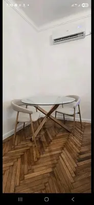 a glass table and a chair in a room at Admiral Gate in Belgrade