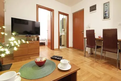a living room with a television and a table at Apartment SEIF 1 in Belgrade