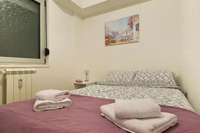 a bedroom with a bed with towels on it at Apartment SEIF 1 in Belgrade