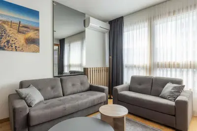 a living room with a couch and a table at N65 LUX Apartment in Belgrade