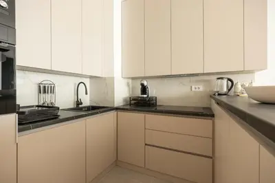 a white kitchen with white cabinets and a sink at N65 LUX Apartment in Belgrade