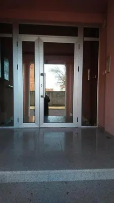 an open glass door of a building with a window at Stan Ledine 65m2 in Novi Beograd