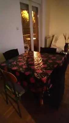a table with a quilt on it in a room at Stan Ledine 65m2 in Novi Beograd
