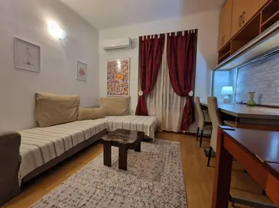 a living room with a couch and a table at Dorcol-Basic Apartman in Belgrade