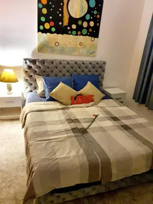 a bedroom with a bed with a painting on the wall at Lavanda in Belgrade