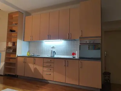 a kitchen with wooden cabinets and a sink at Lavanda in Belgrade