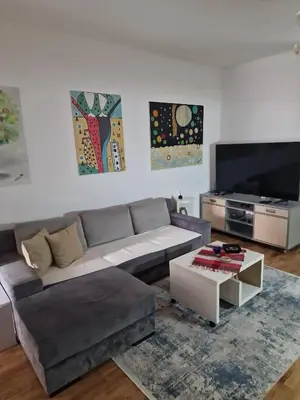 a living room with a couch and a flat screen tv at Lavanda in Belgrade