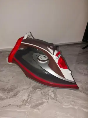 a red and white computer mouse sitting on the floor at Tiny Apartment in Belgrade