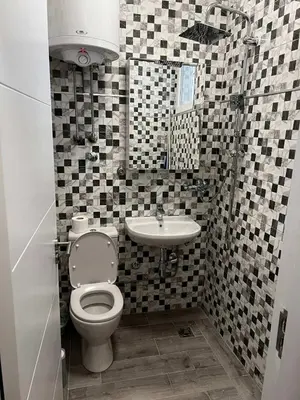 a bathroom with a toilet and a sink at Tiny Apartment in Belgrade