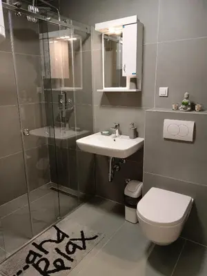 a bathroom with a toilet and a sink and a shower at Zemun residence in Novi Grad