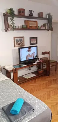 a living room with a television and a table with a bed at TESLA Romantic Cradle-BIG Winter-PROMO Discount in Belgrade