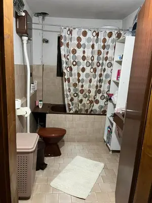 a bathroom with a toilet and a shower curtain at Apartmani Vlaška in Vlaška