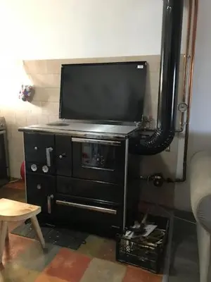 a black dresser with a television on top of it at Apartmani Vlaška in Vlaška
