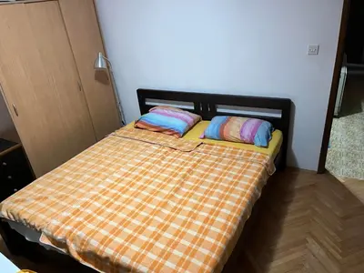 a bed with two pillows on it in a room at Apartmani Vlaška in Vlaška