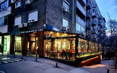 a store front of a building on a city street at Erste City Apartment in Sajmište