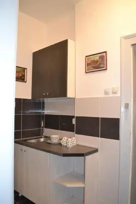 a kitchen with black and white tile on the wall at BelgradeCity center-Lekic apart 1 in Belgrade