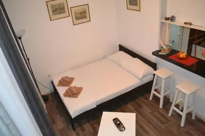 a small room with a bed and two stools at BelgradeCity center-Lekic apart 1 in Belgrade
