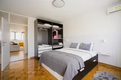 a bedroom with a large bed in a room at Victor Nest Double Room Apartment in Belgrade