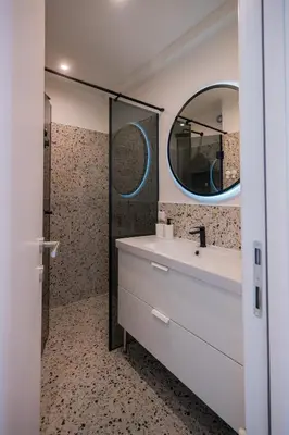 a bathroom with a sink and a mirror at Victor Nest Double Room Apartment in Belgrade